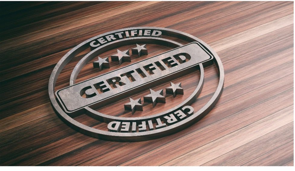 wood background with raised metal Certified badge