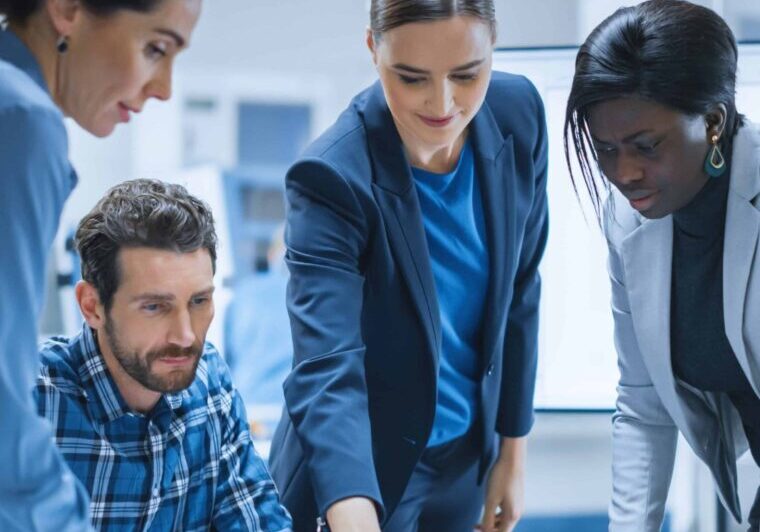 Busy Diverse Team of Computer Engineers and Specialists Gather Around Conference Table, They Discuss Project Drafts and Blueprints, Find Problem Solutions. Industrial Technology Office Meeting Room